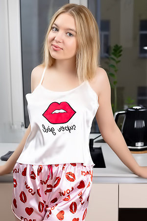 Nikoletta Showcases Her Blonde Allure In A Topless Kitchen Pose With Red Nails
